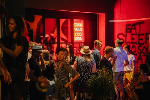 Group of People Standing Waiting Outside The Bar