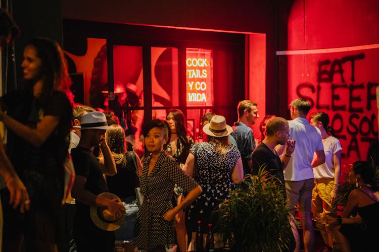 Group Of People Standing Waiting Outside The Bar