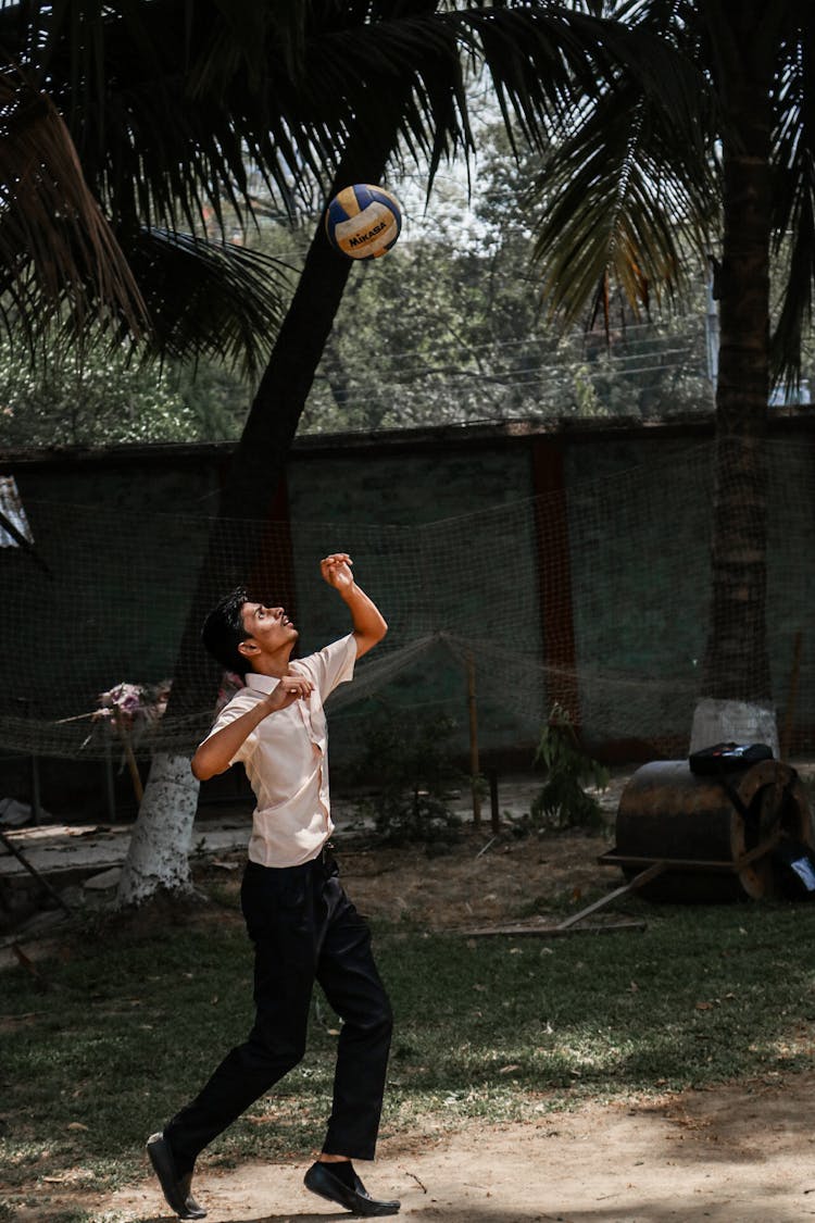 Man Wearing School Uniform Playing Volleyball                   