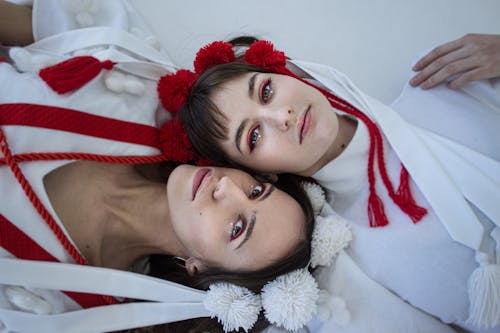 Women in Traditional Clothing and Makeup Lying on Back