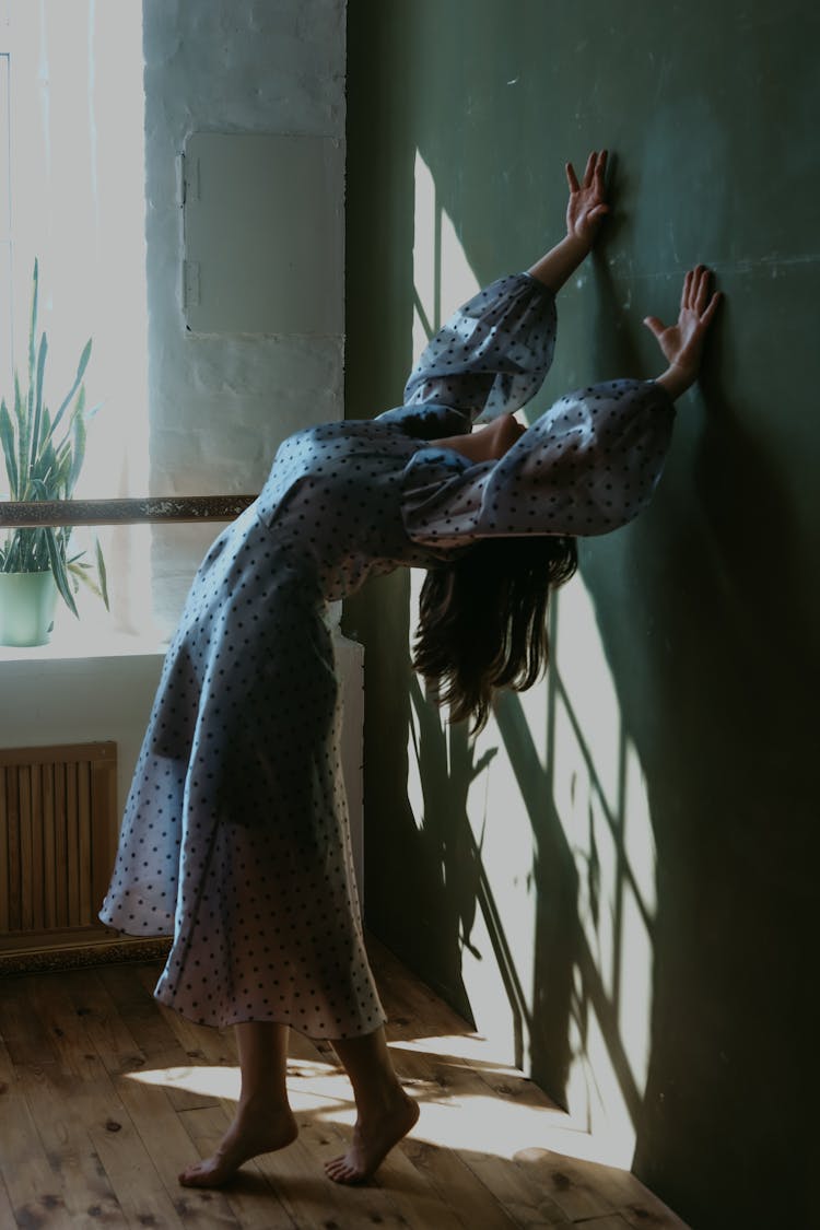 Woman Bending Backwards And Touching A Wall 