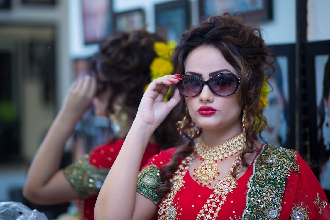 Woman Wearing Red Dress Holding Her Black Framed Sunglasses