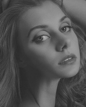 Graceful black and white portrait of a woman with expressive eyes.