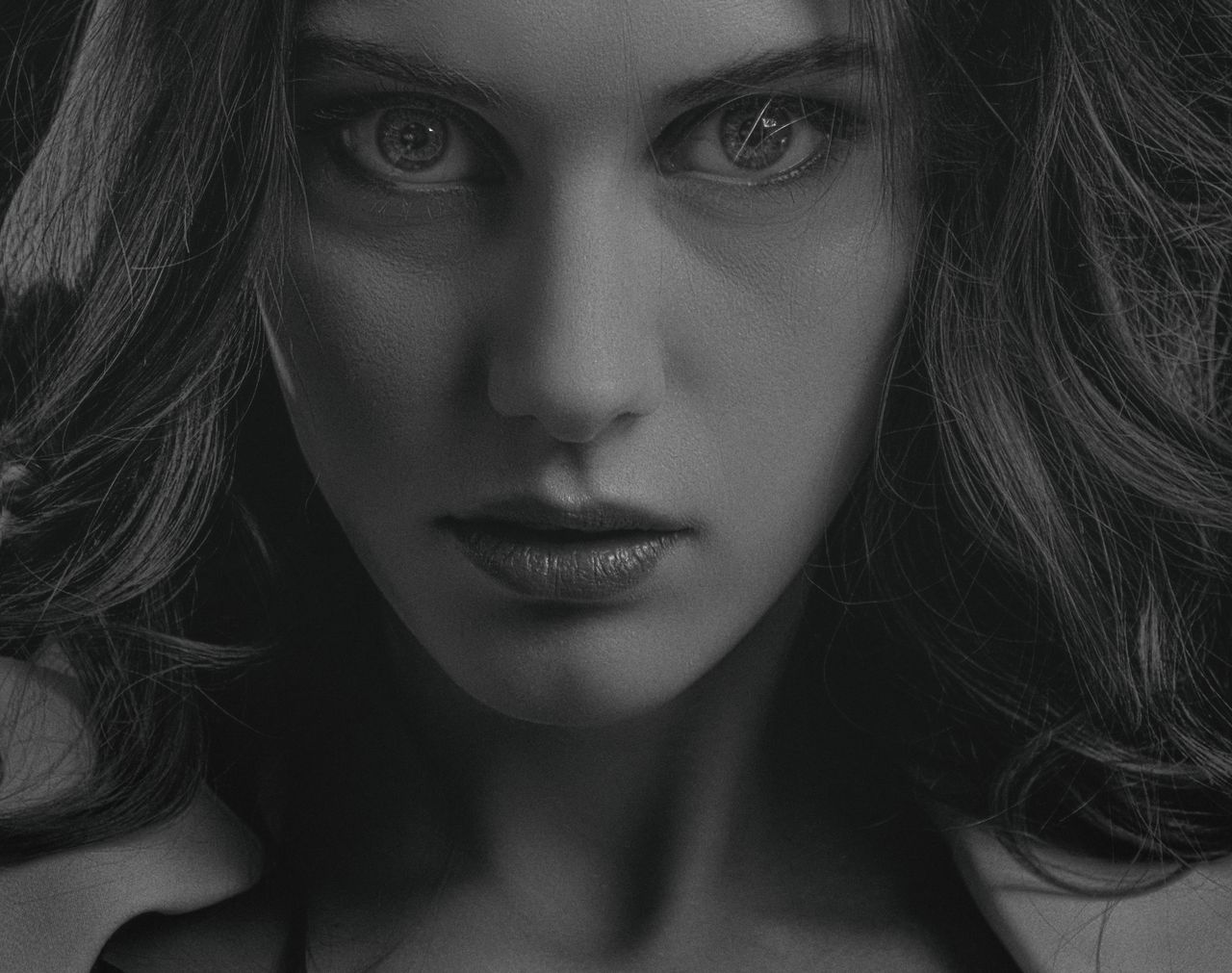 close up black and white portrait of a serious woman with intense gaze