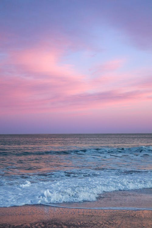Ocean Waves Crashing on Shore at Sunset · Free Stock Photo