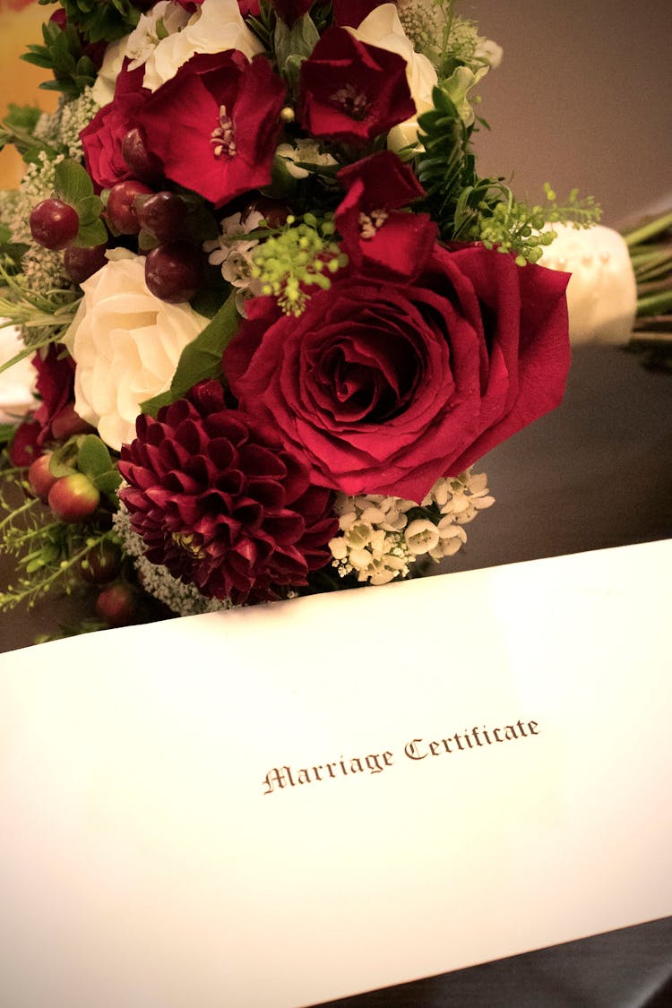 Bouquet Of Flowers Beside Marriage Certificate 