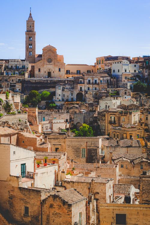 Free Stunning aerial view of Matera's ancient architecture under a clear blue sky. Stock Photo