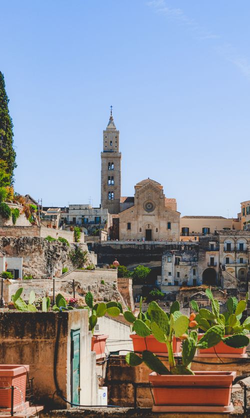 Free Explore the ancient and scenic architecture of Matera, Italy's unique townscape with its historic church and vibrant surroundings. Stock Photo