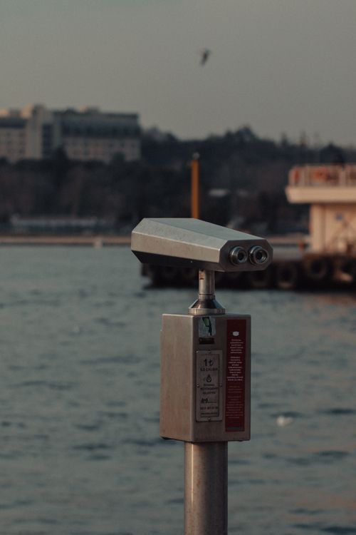 Free A distant view from a coin-operated binoculars by the waterfront on a cloudy day. Stock Photo