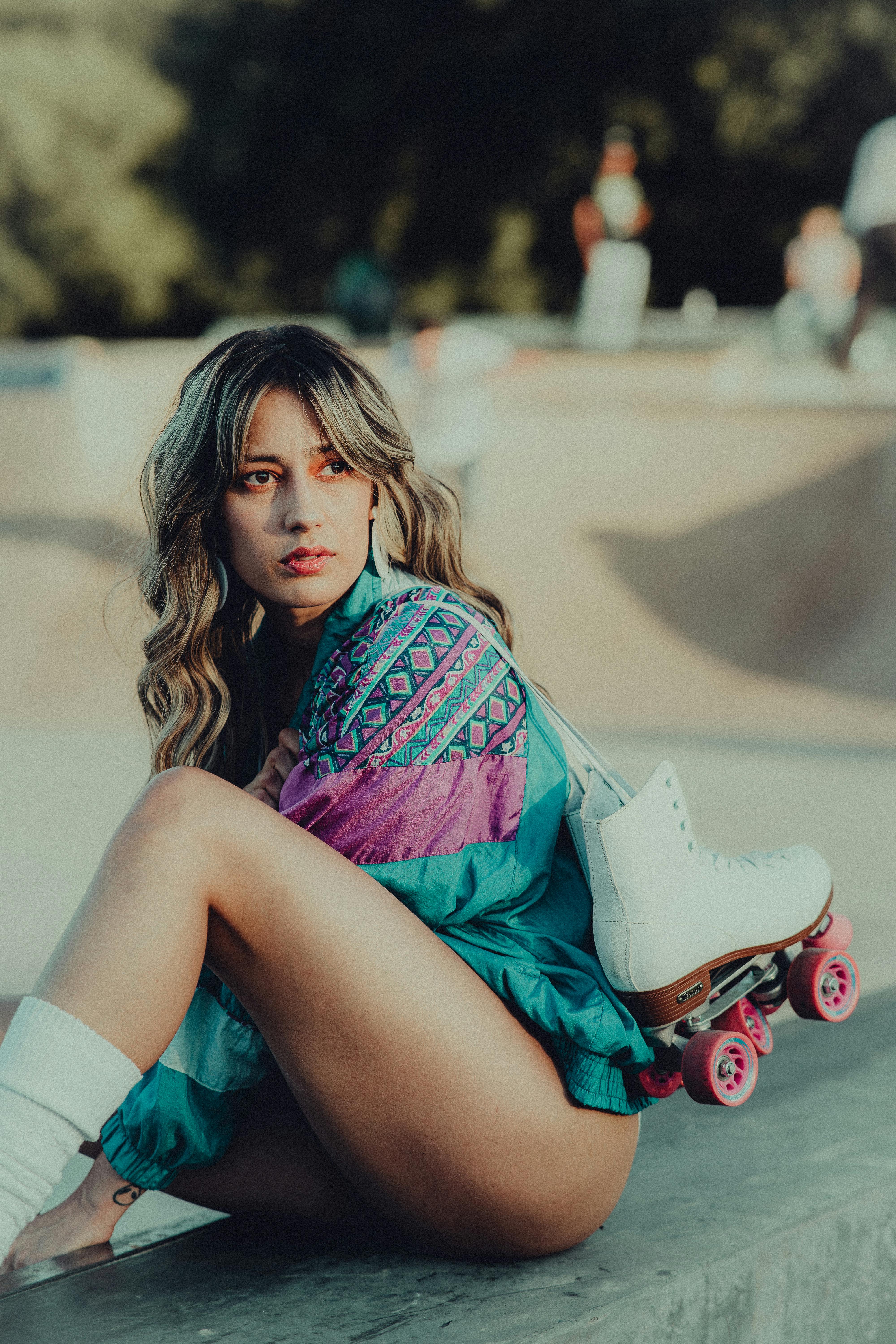 woman wearing jacket holding roller skates