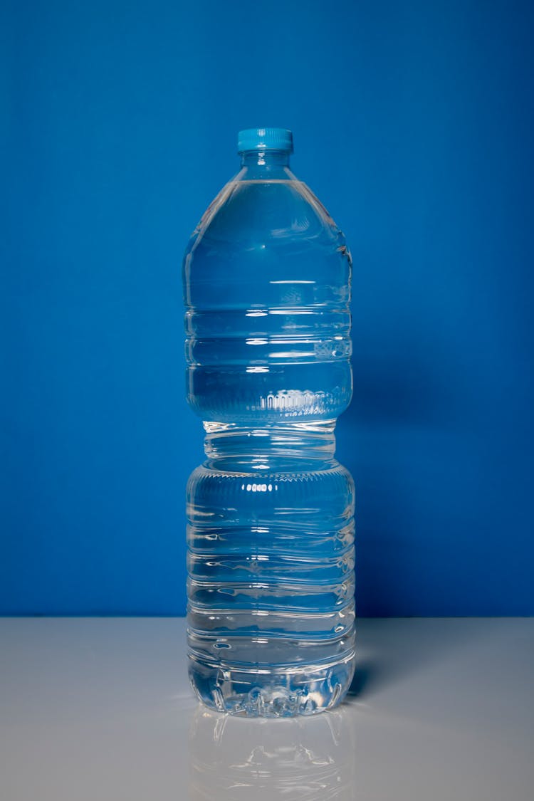 A Clear Plastic Bottle In Blue Background