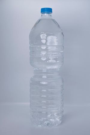 Clear plastic water bottle on a white backdrop — photo by nerea arance on Pexels
