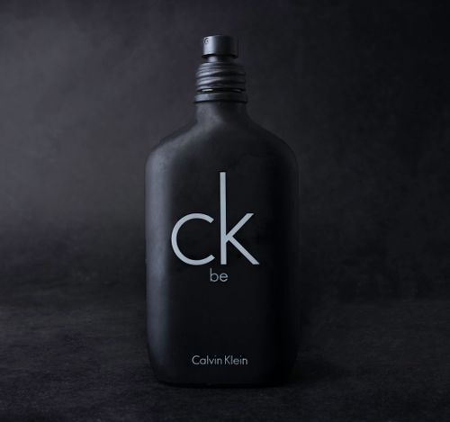 Free Close-up of Calvin Klein CK Be perfume bottle with dark background. Stock Photo