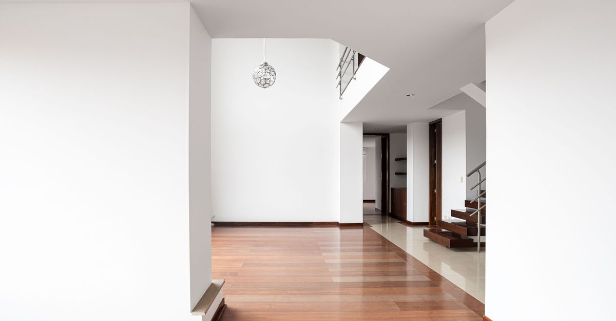 Spacious minimalist apartment interior with wooden flooring in Bogotá, Colombia.