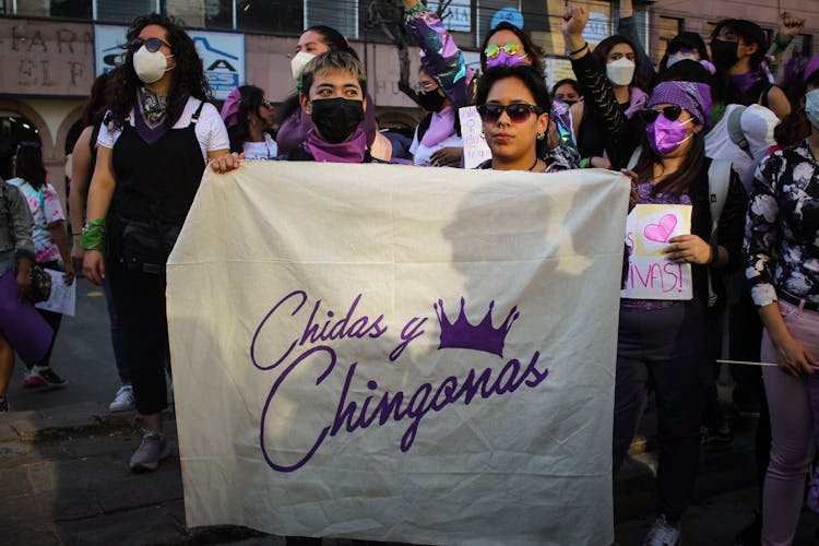 People Holding A Banner