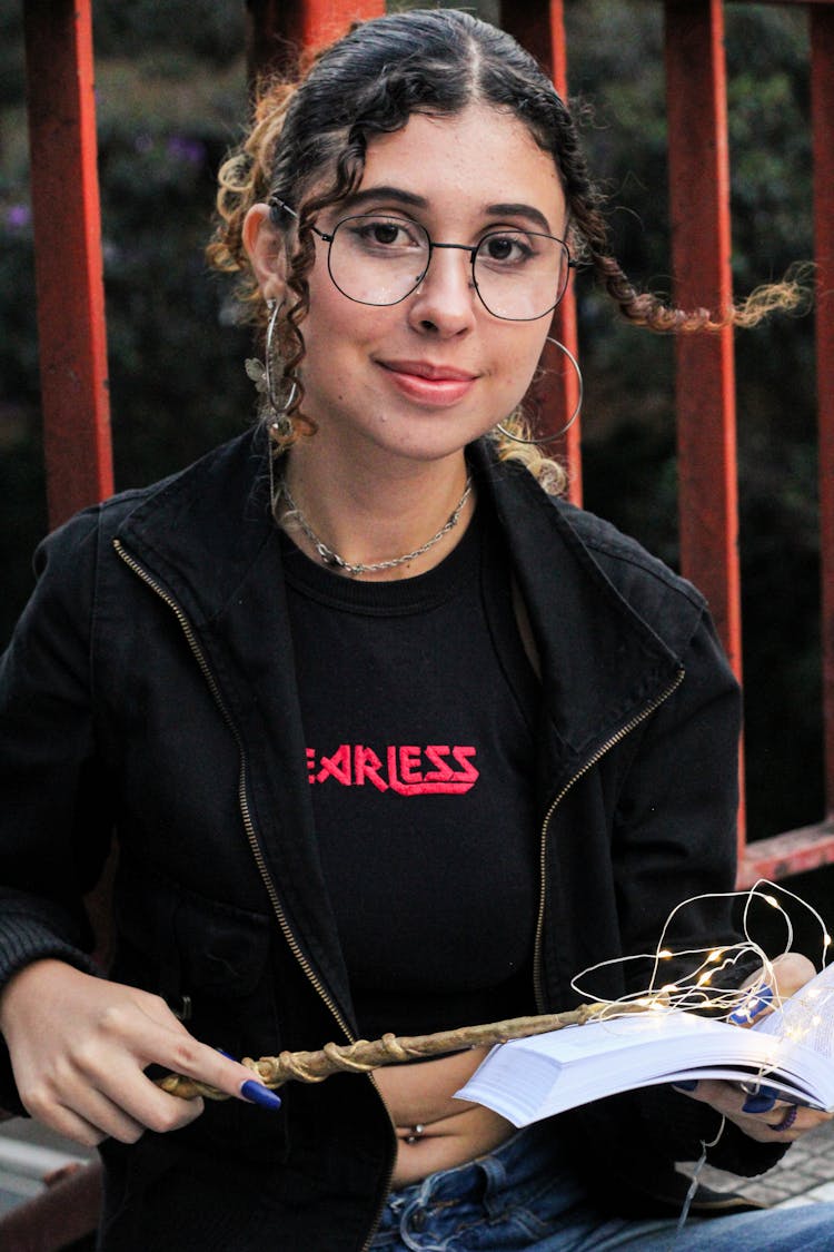 Woman Wearing Black Jacket Holding Wand