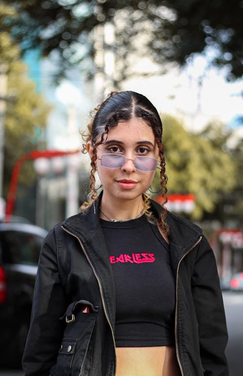 Woman Wearing Black Jacket and Purple Sunglasses Smiling