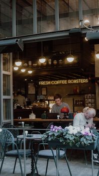 A vibrant Istanbul sidewalk cafe featuring 'Fresh Coffee Roasters' with patrons enjoying beverages.
