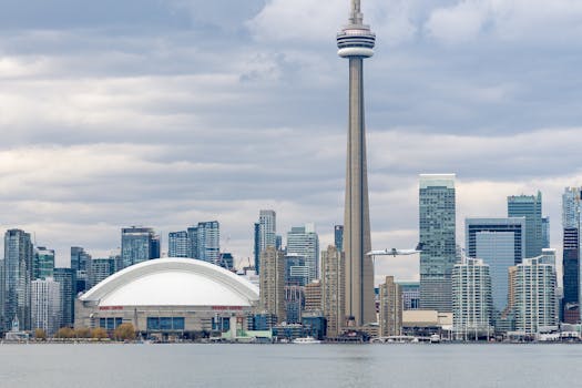 Toronto skyline with CN Tower, modern skyscrapers, and waterfront view.