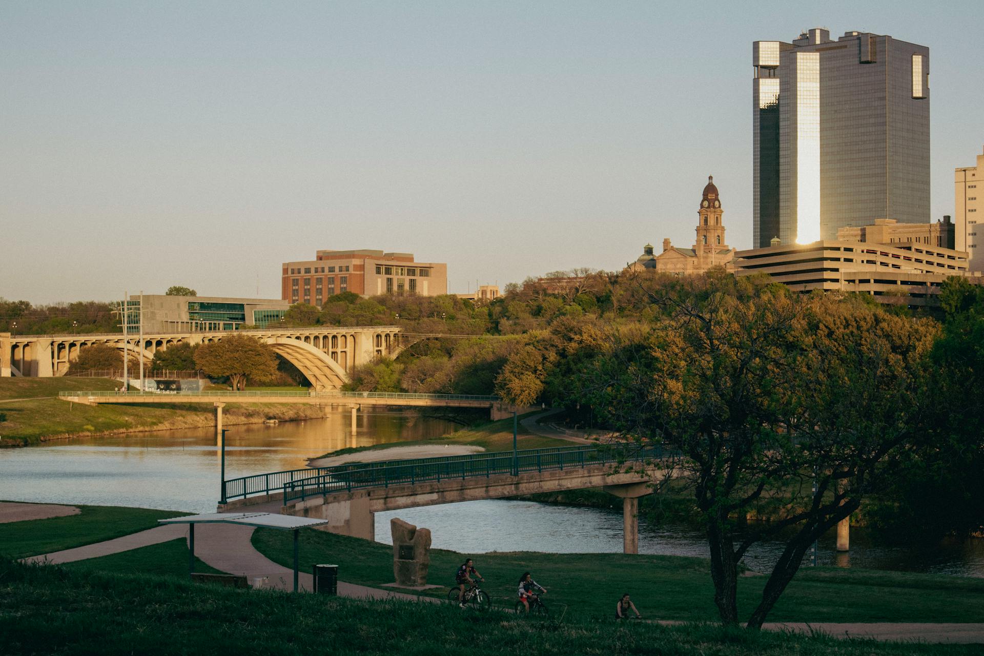 Tranquil Fort Worth skyline with bridges over Trinity River at sunset, Texas.