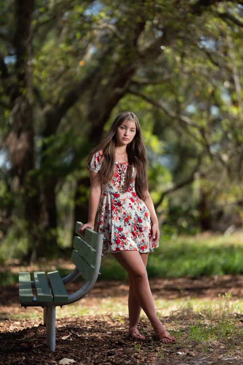 Woman in Floral Dress Leaning on Railing · Free Stock Photo