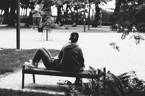 Foto Grayscale Dari Pasangan Yang Sedang Duduk Di Bangku