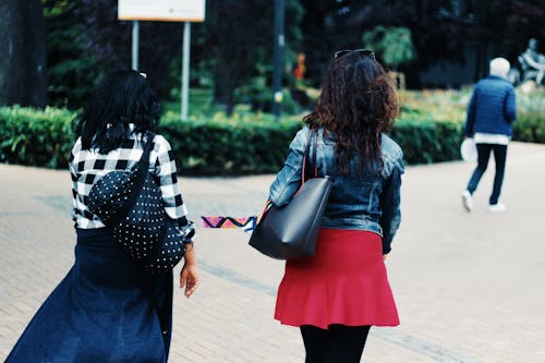 Woman in Blue Denim Jacket and Red Skirt