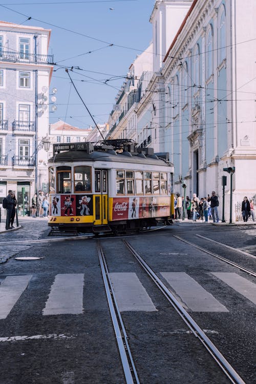 A Tram Cable Car on Road Near Pedestrian Lane