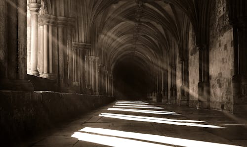 Grayscale Photo of Light Cast on Hallway