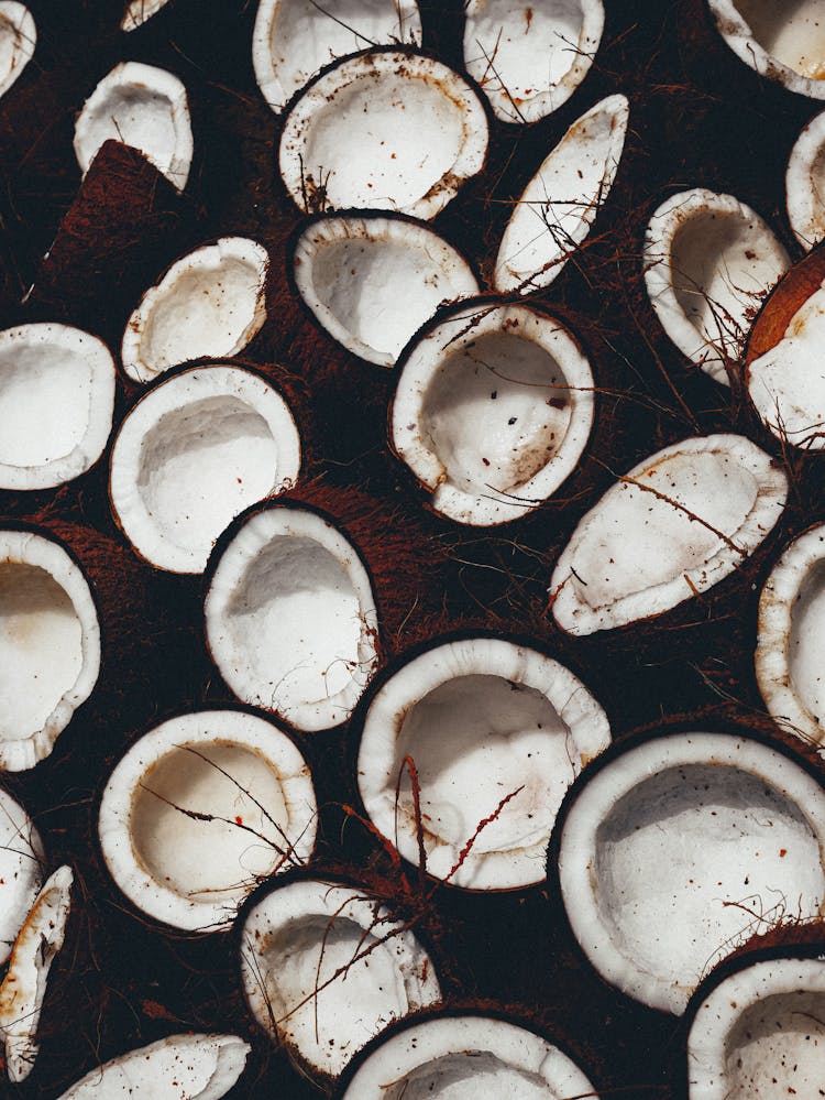 A Bunch Of Fresh Coconuts Cut In Half