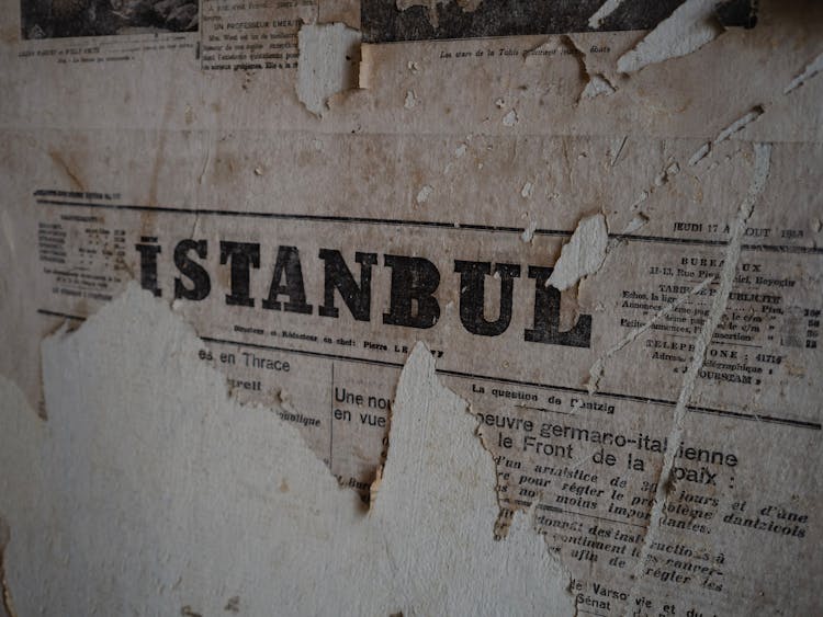 Torn Newspaper On Wall