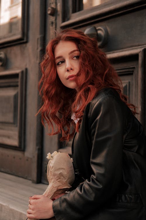 Woman with Red Hair Wearing a Black Leather Jacket
