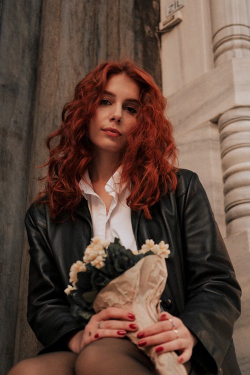 Young Redhead Woman Holding Flowers 