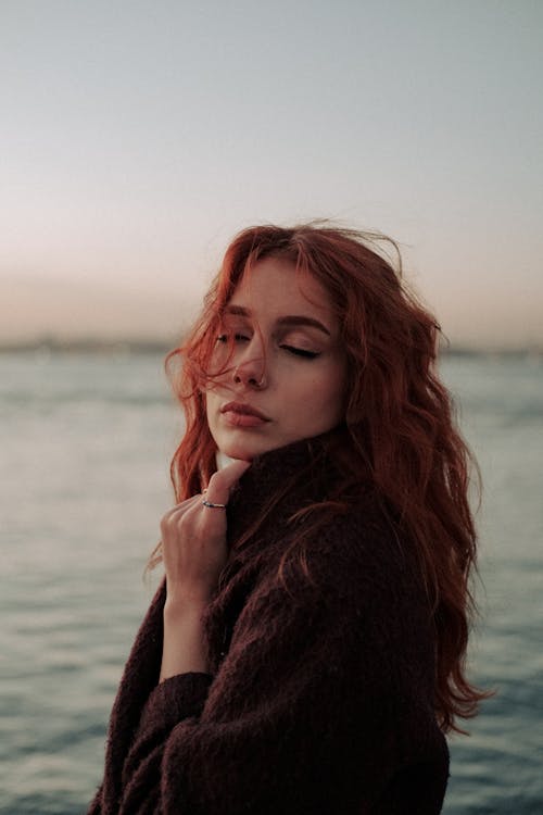 Portrait of a Redhead with her Eyes Closed
