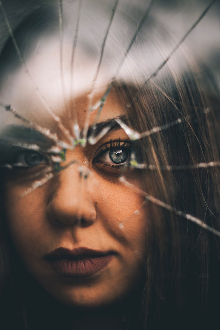 Portrait Of Woman Seen Through Cracked Window