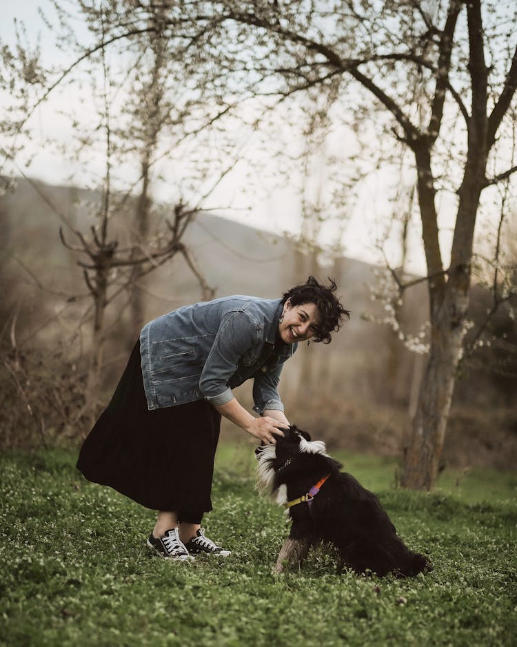 Laughing Woman Playing With A Dog