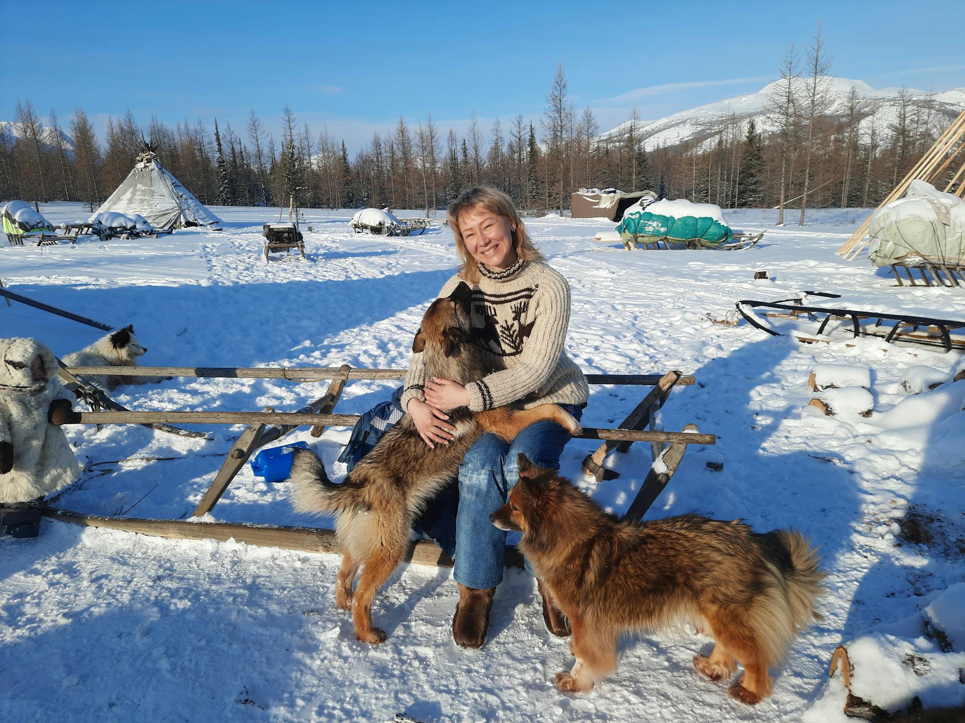 Happy Woman with Dogs in Winter