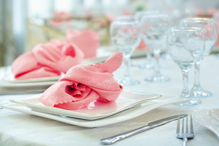 Elegant Pink Napkins And Glassware On The Table 