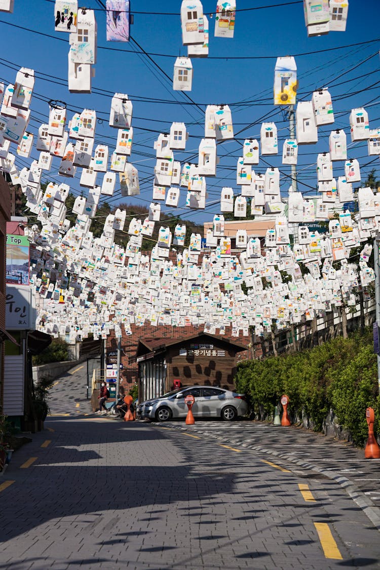 Decorations Hanging On Lines Above The Road 