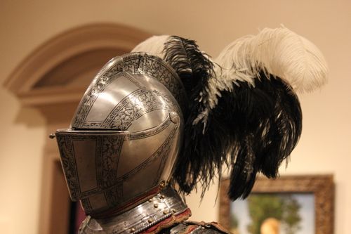 Free Close-up of an ornate medieval helmet with feathers on display at a museum exhibition. Stock Photo