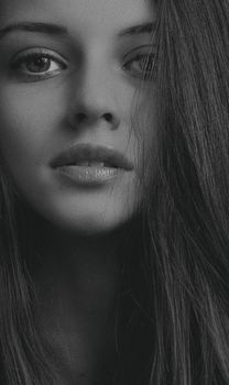 Sophisticated close-up black and white portrait of a young woman.