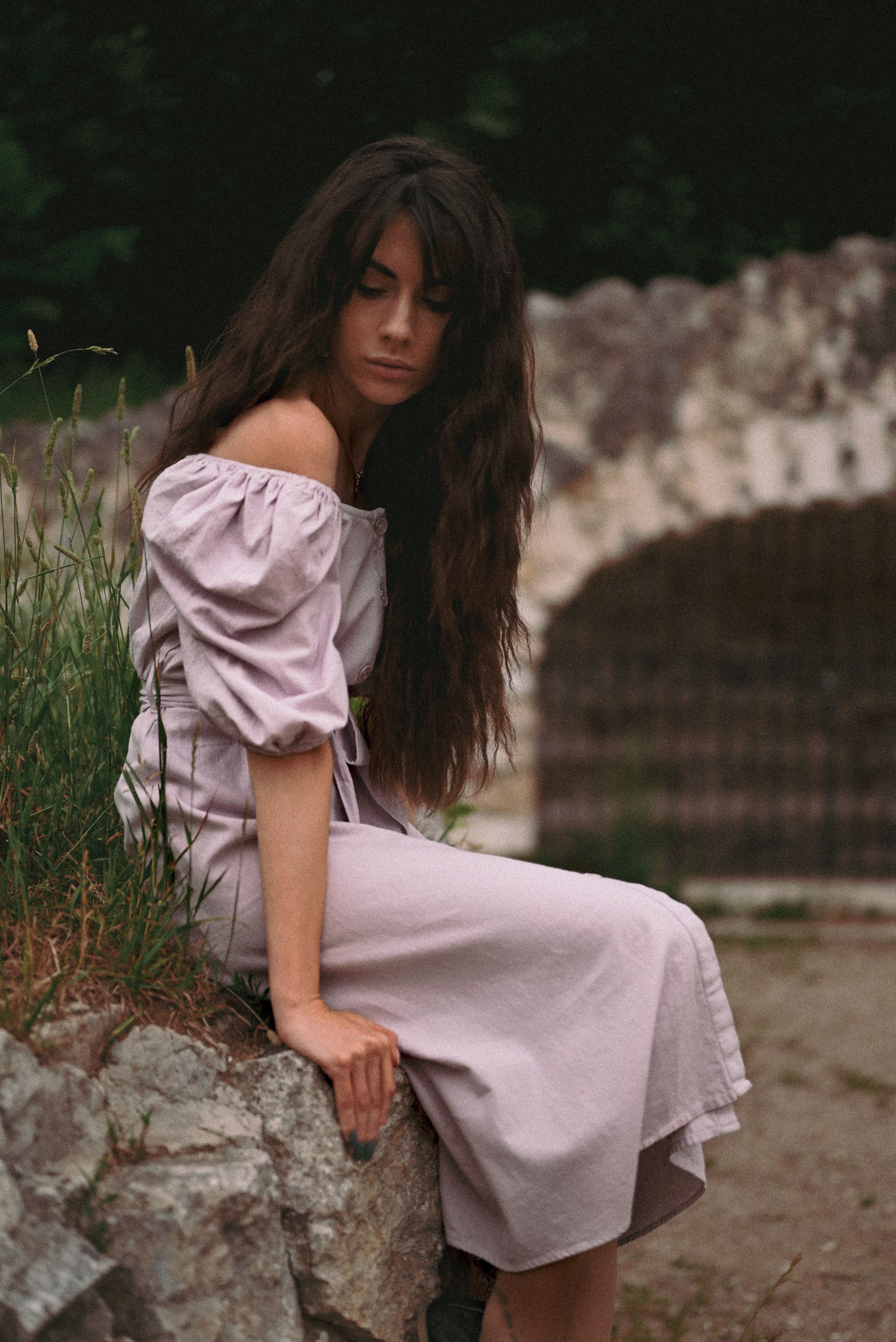 A Woman in White Beige Off Shoulder Dress Sitting on Rock · Free Stock ...