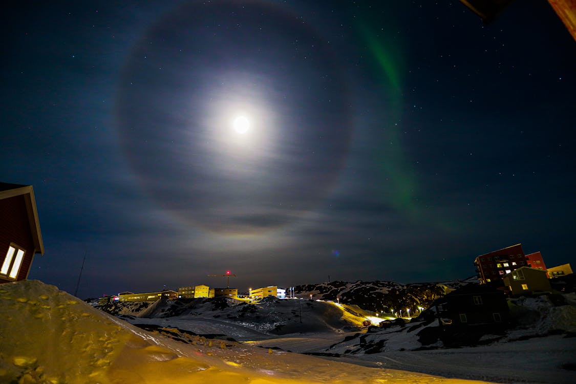 Mountain Village Under Full Moon at Night 