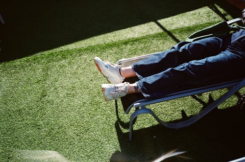 Shoes of a Person in Denim Pants