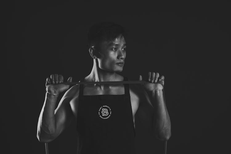 Grayscale Portrait Of A Man Holding A Resistance Band