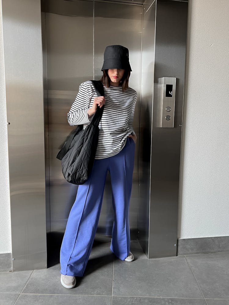 Woman In A Striped Blouse And Pants 