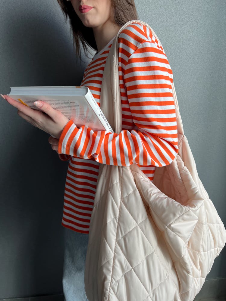 Woman In Blouse Holding Book