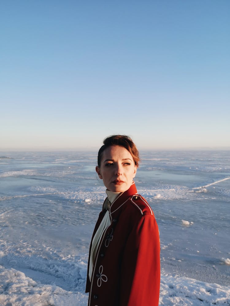 Beautiful Woman Standing On Frozen Lake