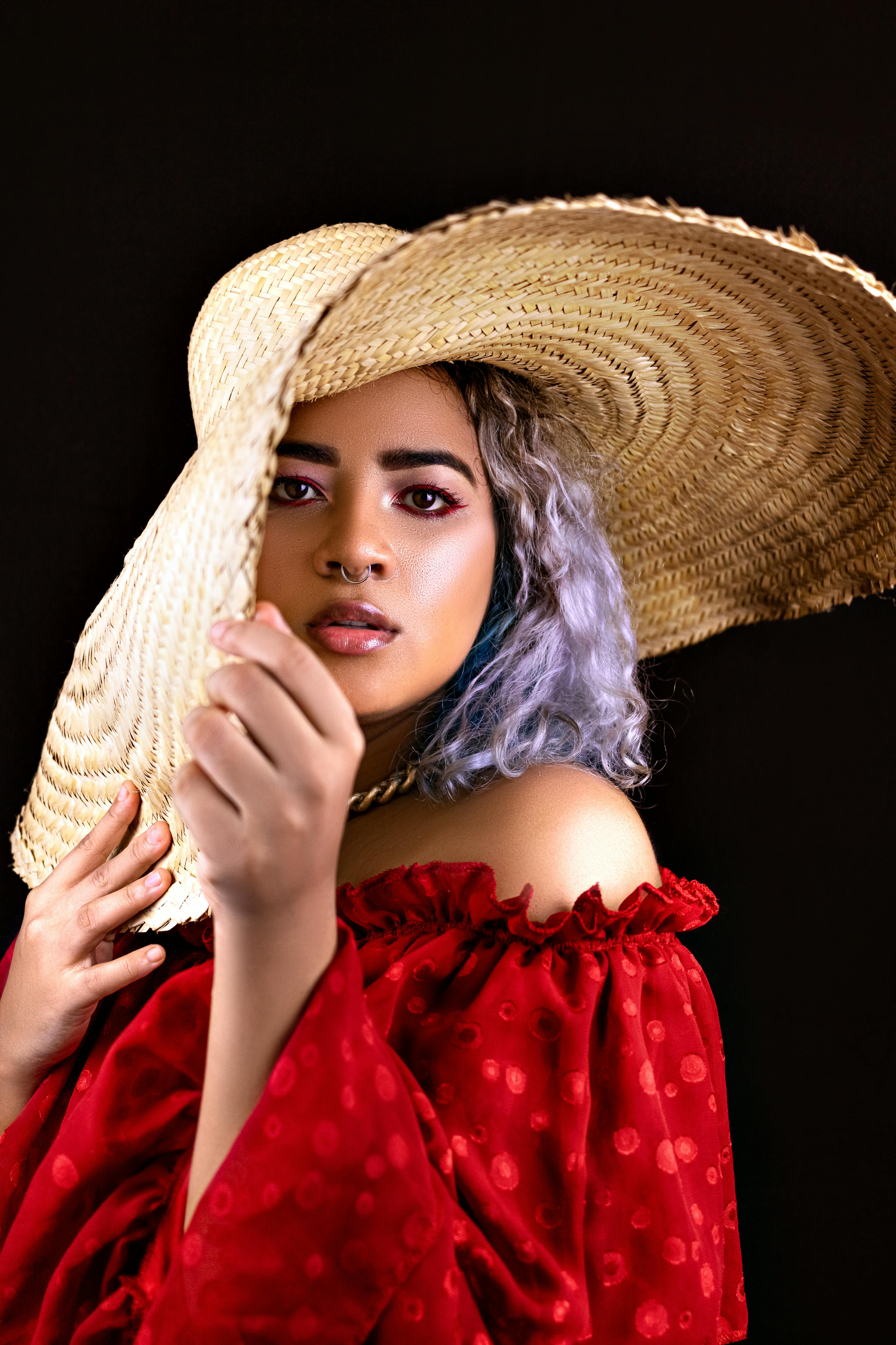 woman in red dress wearing brown straw hat