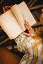 Woman Flicking Pages of a Book in Library 